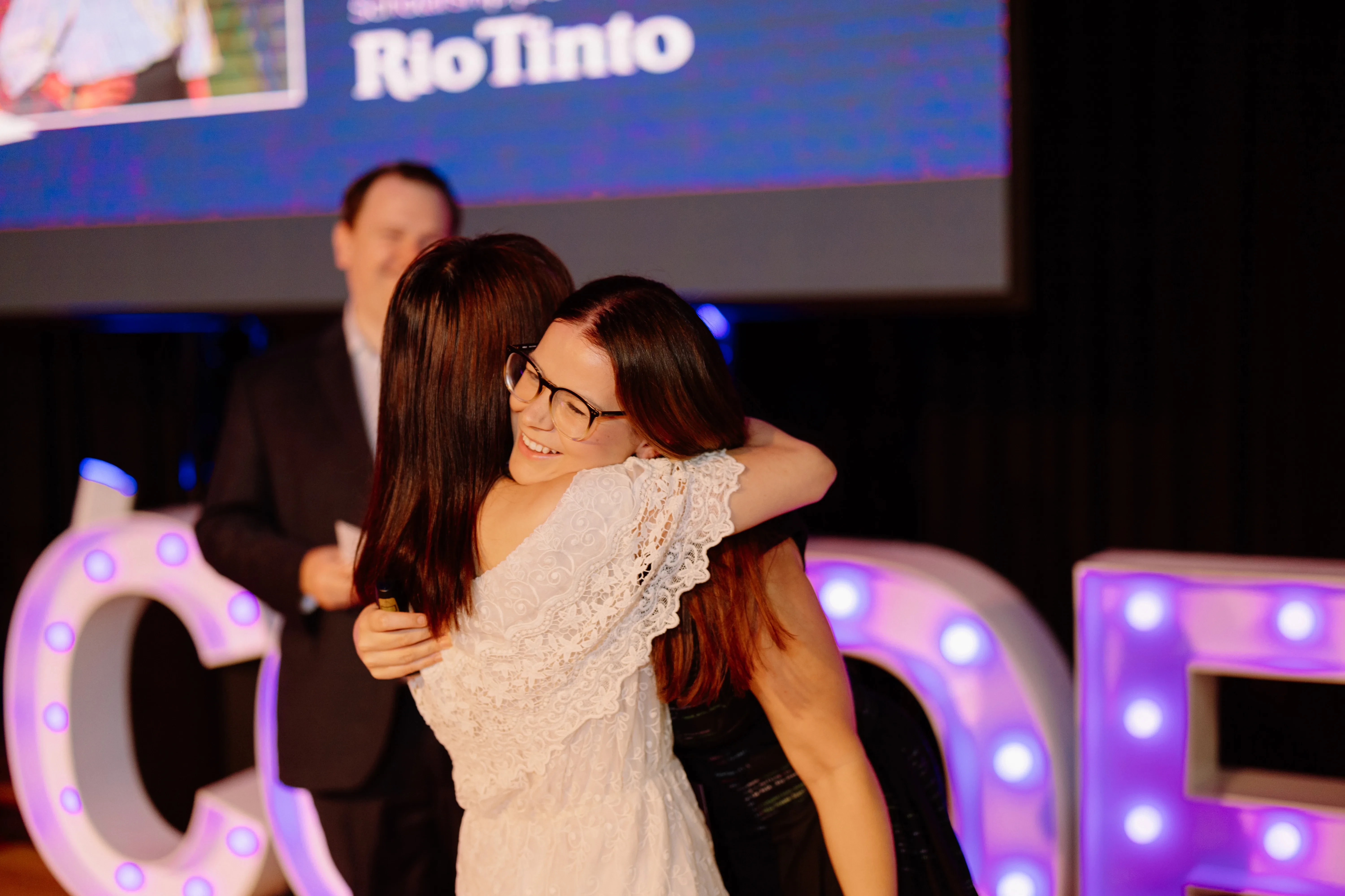 Attendees embracing at a She Codes Australia Brisbane event